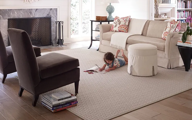 Girl playing on custom rug in living room | Castle Carpets and Interiors